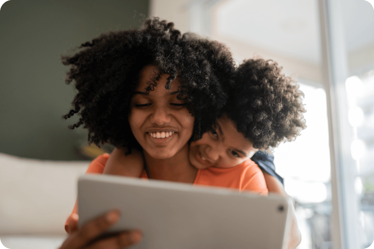 A mother and child having fun on a tablet